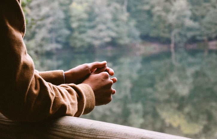 hands-leaning-looking-out-nature