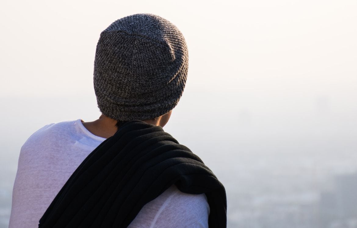 man-with-hat-looking-out-over-horizon
