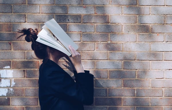 woman-brickwall-with-book