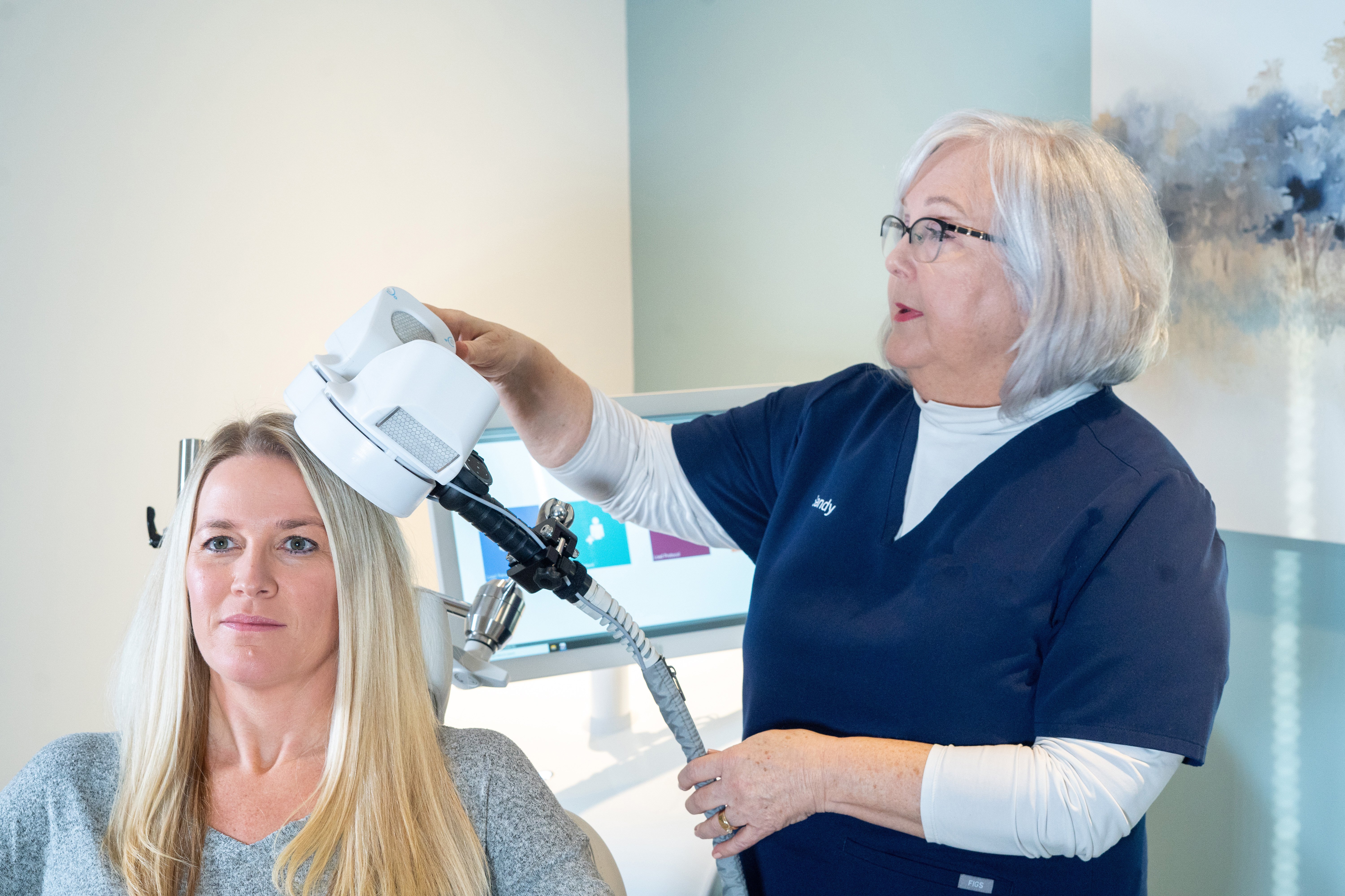 TMS application and coil placement shown on a woman 