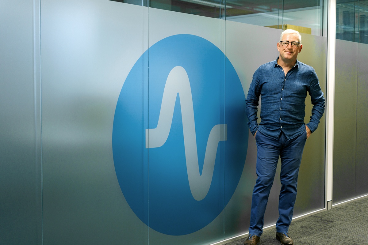 neurocare-founder-tom-mechtersheimer-standing-by-neurocare-logo-1