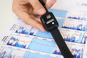 Actigraphy Sleep Assessment wristband and a report chart