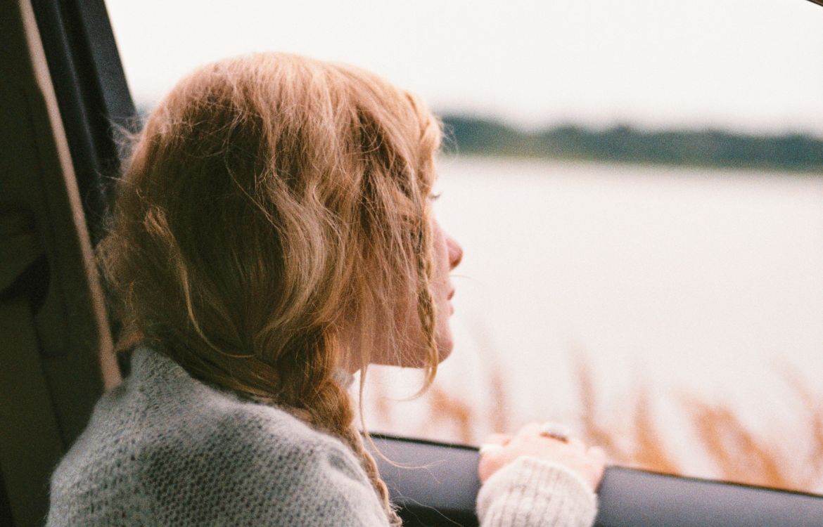 female-looking-out-car-window