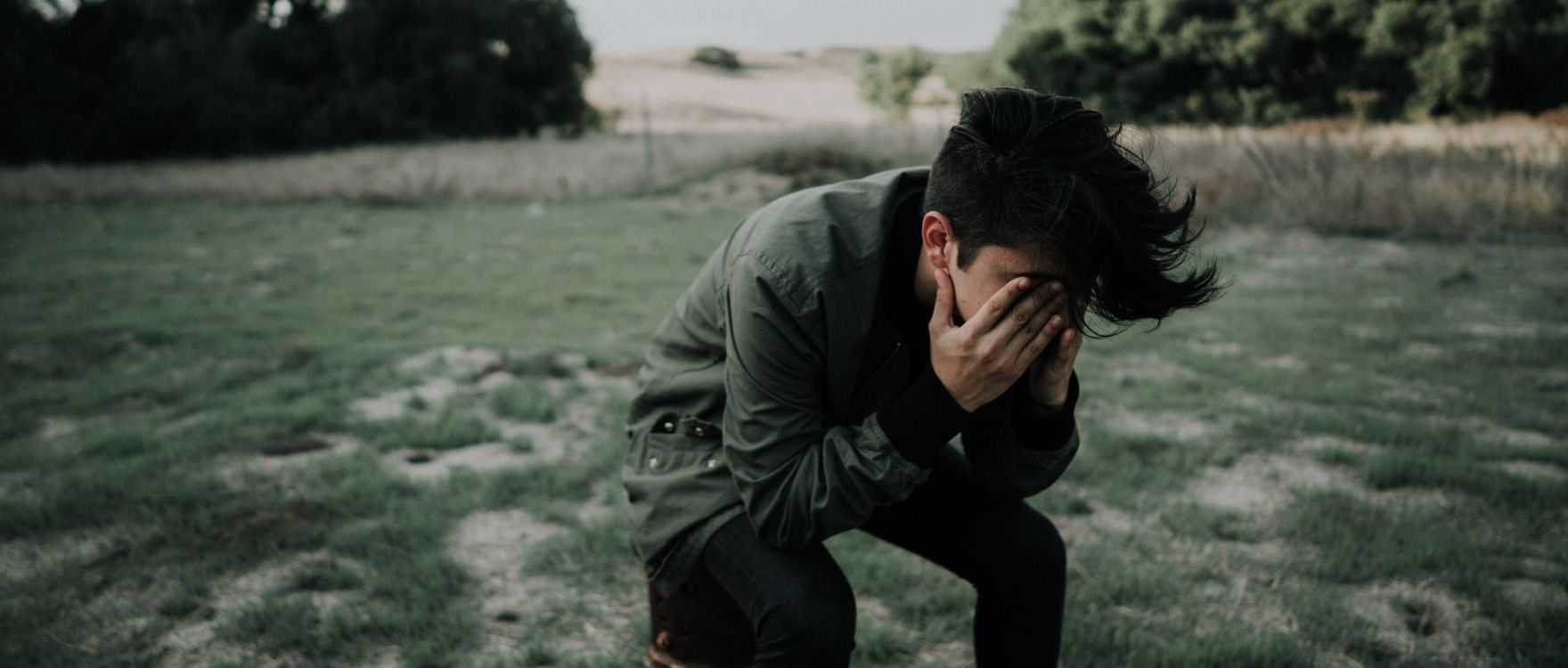 young-man-nature-head-in-hands